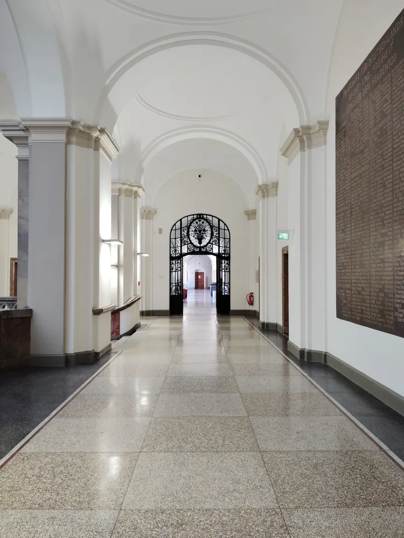 A polished terrazzo corridor under arched ceilings