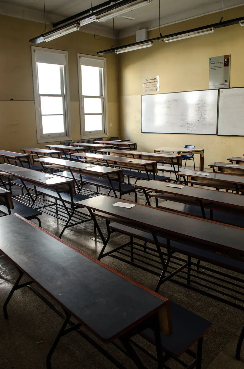 A tidy classroom with rows of desks and a whiteboard